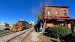 WE 7023 leads 50 empty cars past the depot.